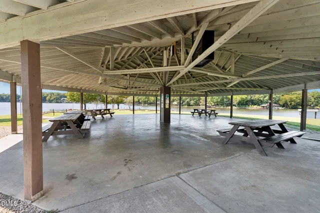 a swimming pool with outdoor seating and yard