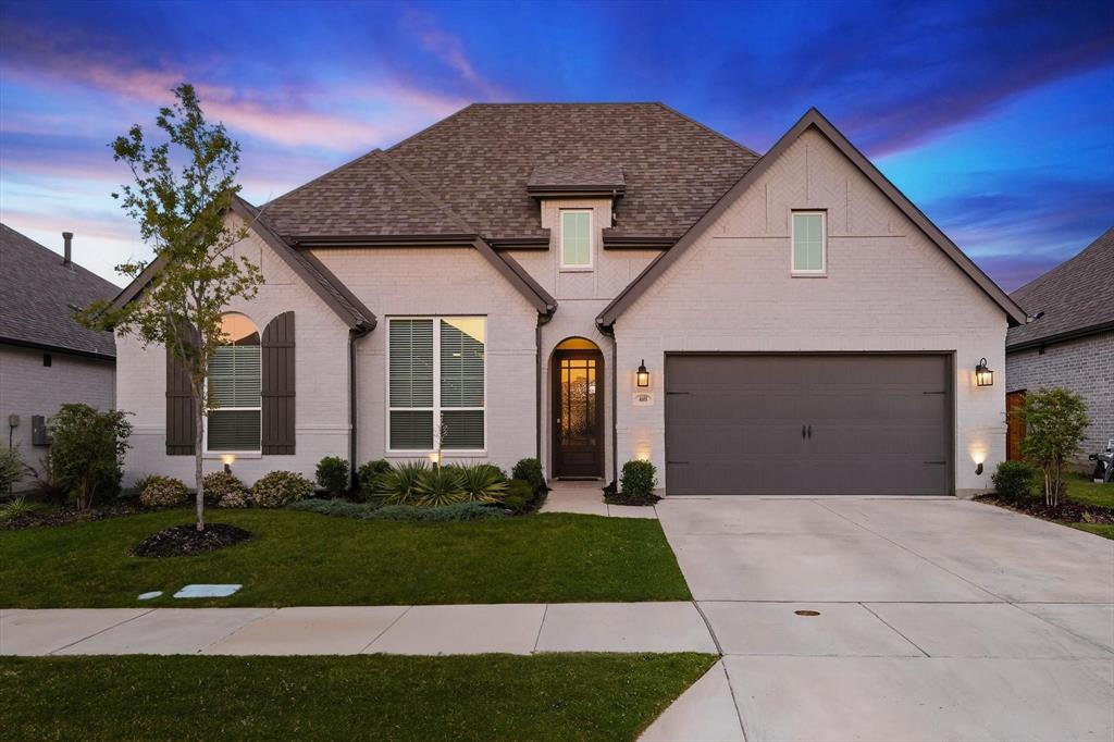 a front view of a house with a garden and plants