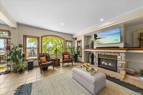 a living room with furniture large window and a fireplace