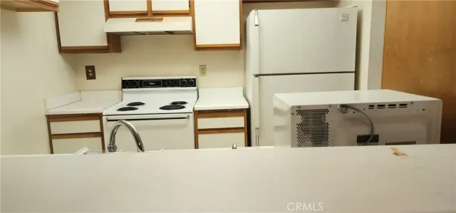 a view of kitchen with cabinets