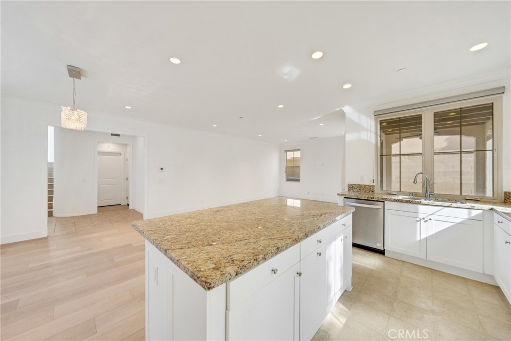 107 Hanging Garden Irvine, CA 92620 - Photo 12 of 26 a kitchen with stainless steel appliances granite countertop a sink and a granite counter tops