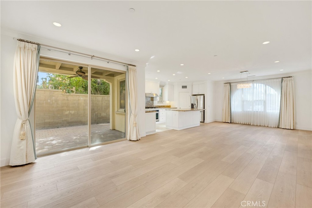 107 Hanging Garden Irvine, CA 92620 - Photo 13 of 26 a view of an empty room with a sliding door