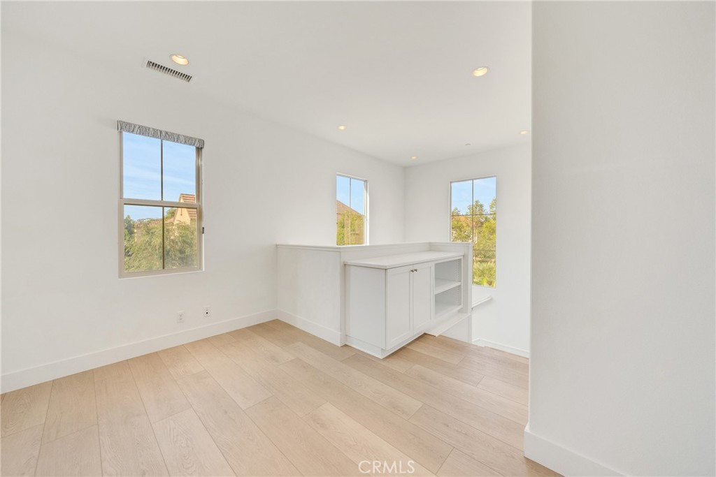 107 Hanging Garden Irvine, CA 92620 - Photo 14 of 26 wooden floor in an empty room with a window
