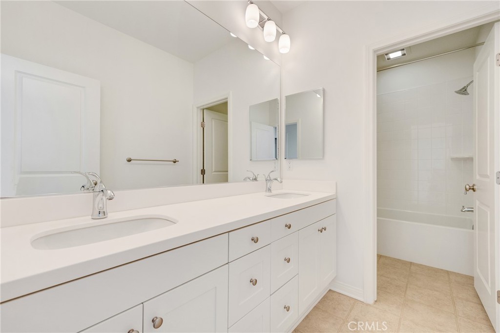 107 Hanging Garden Irvine, CA 92620 - Photo 16 of 26 a bathroom with a double vanity sink mirror and shower