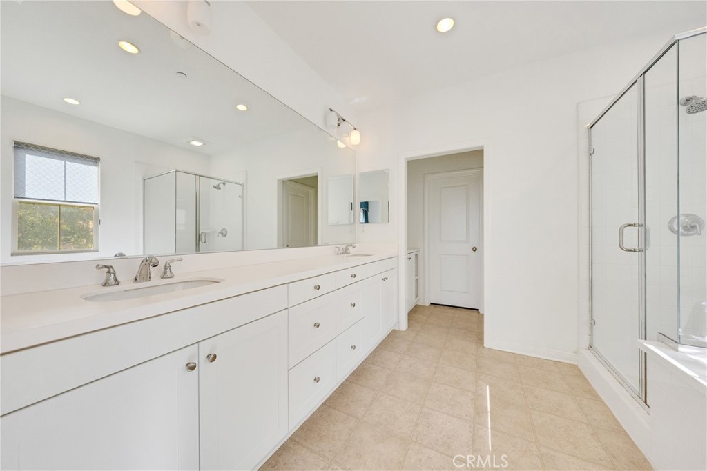 107 Hanging Garden Irvine, CA 92620 - Photo 19 of 26 a spacious bathroom with a double vanity sink and mirror