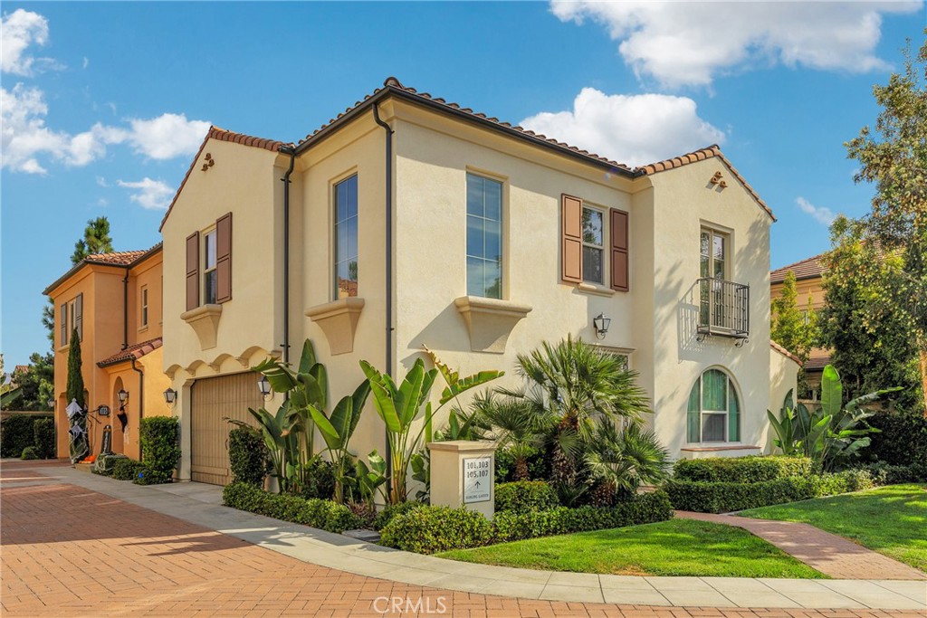 107 Hanging Garden Irvine, CA 92620 - Photo 2 of 26 a front view of a house with garden