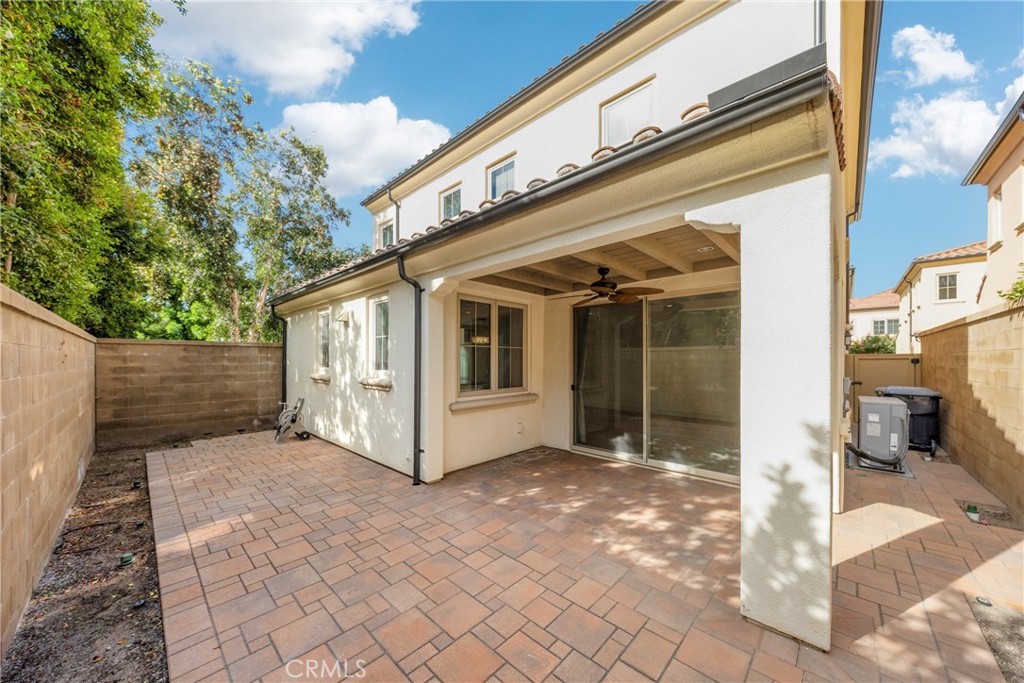 107 Hanging Garden Irvine, CA 92620 - Photo 24 of 26 a view of a white house with a large window and yard