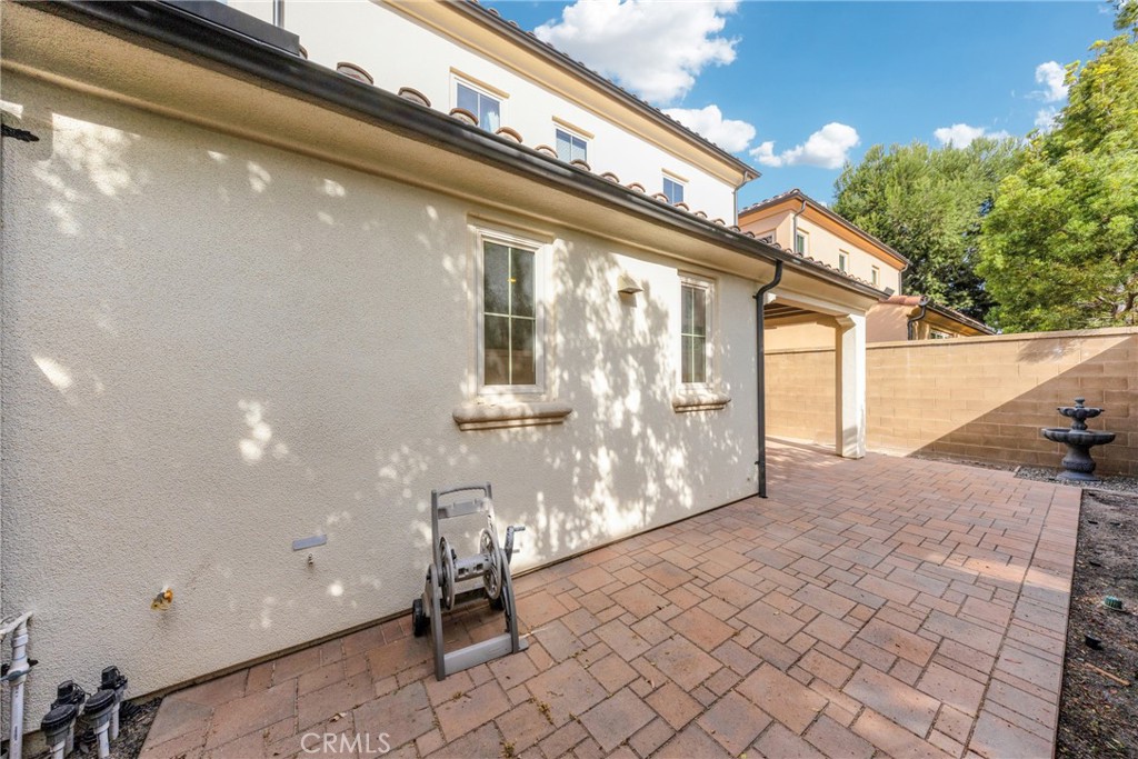 107 Hanging Garden Irvine, CA 92620 - Photo 25 of 26 a view of a porch with a table and chairs and floor