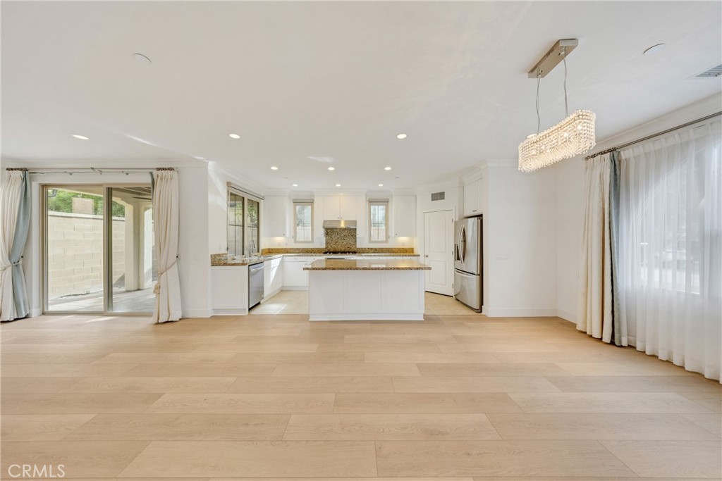107 Hanging Garden Irvine, CA 92620 - Photo 4 of 26 a view of kitchen with refrigerator and window