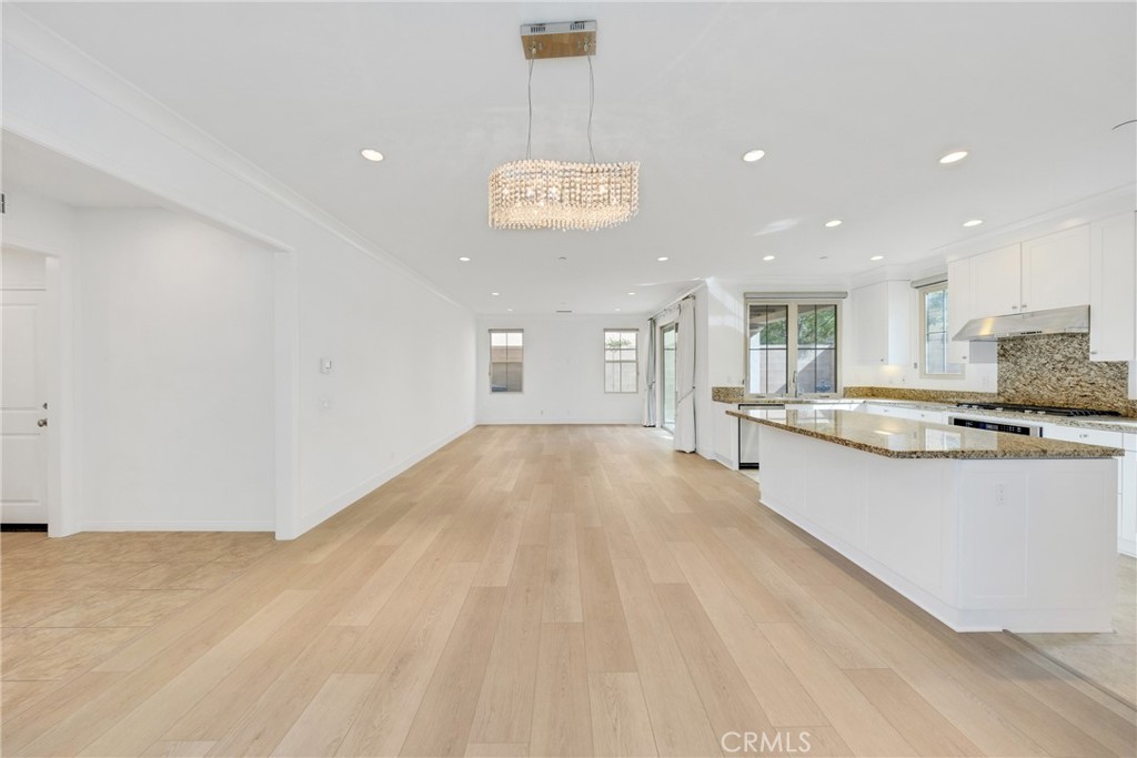 107 Hanging Garden Irvine, CA 92620 - Photo 7 of 26 a view of kitchen with stainless steel appliances granite countertop cabinets and wooden floor