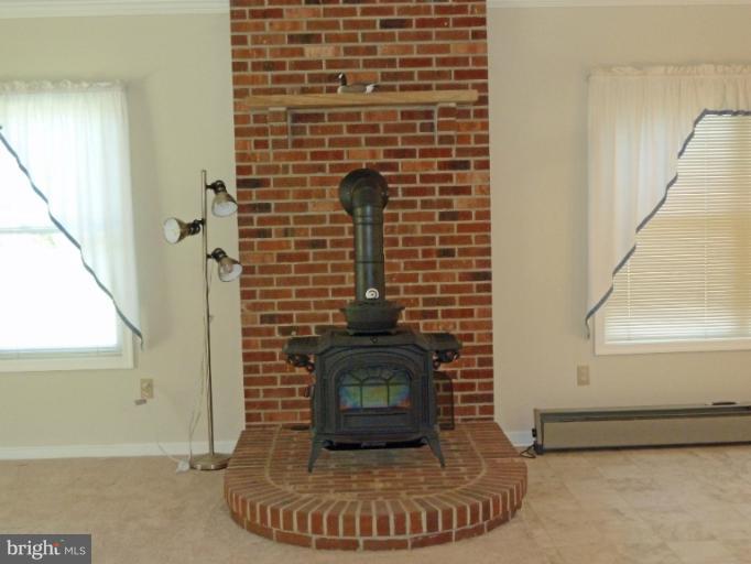 1020 Wagner Point Road Cambridge, MD 21613 - Photo 15 of 26 Woodstove on brick hearth