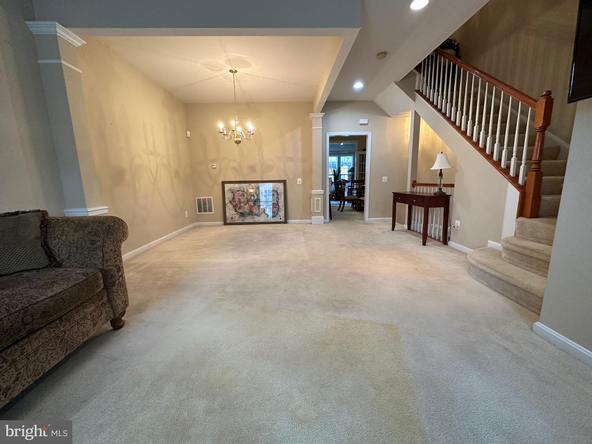 8935 Singleleaf Circle Lorton, VA 22079 - Photo 4 of 6 a view of a livingroom with furniture and staircase