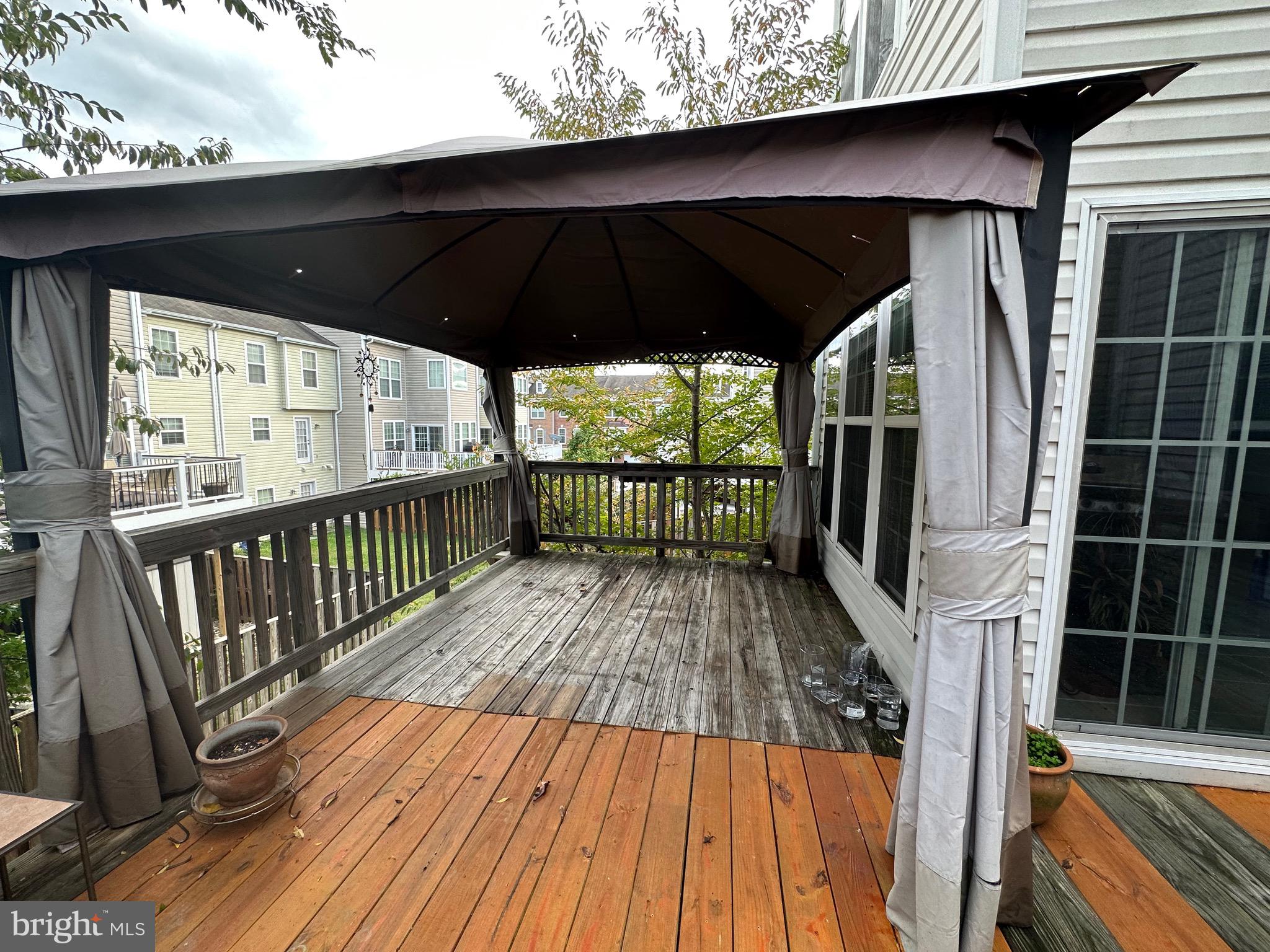 8935 Singleleaf Circle Lorton, VA 22079 - Photo 6 of 6 a view of deck with wooden floor and outdoor seating