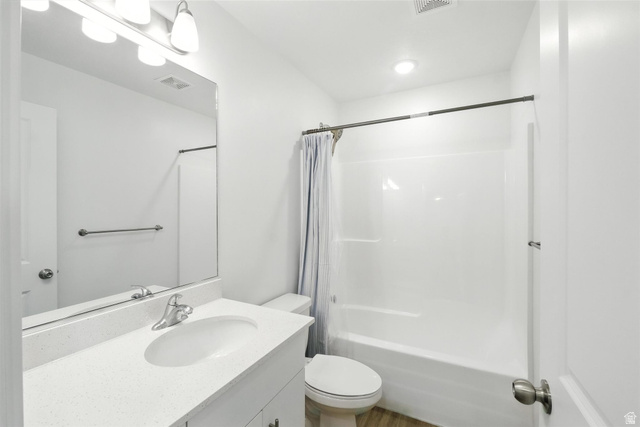 1221 West 1870 South Logan, UT 84321 - Photo 10 of 20 Bathroom featuring a white vanity with an integrated sink, polished chrome faucet, and expansive wall-mounted mirror