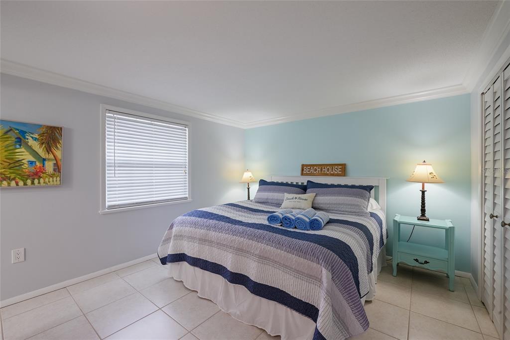 120 Maple Avenue Anna Maria, FL 34216 - Photo 15 of 39 a bedroom with a bed and a window
