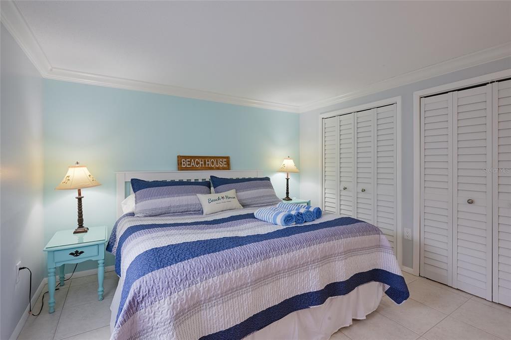 120 Maple Avenue Anna Maria, FL 34216 - Photo 16 of 39 a bedroom with a bed and a lamp