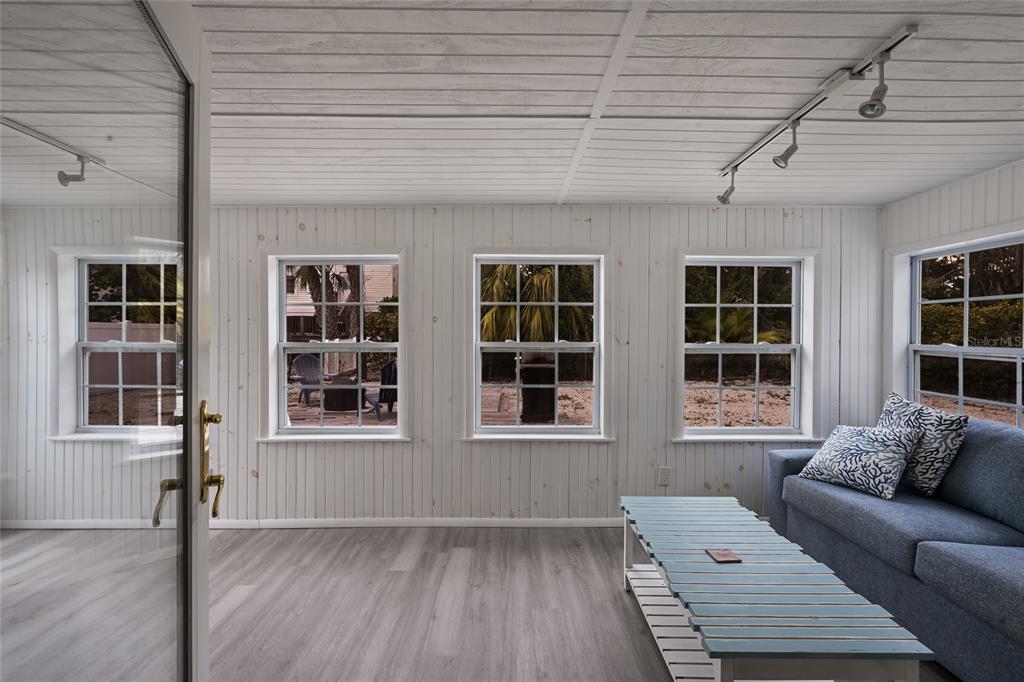 120 Maple Avenue Anna Maria, FL 34216 - Photo 22 of 39 a living room with furniture and windows