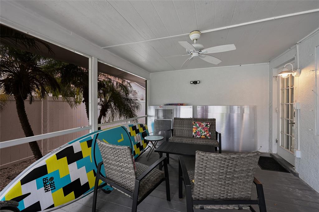 120 Maple Avenue Anna Maria, FL 34216 - Photo 29 of 39 a living room with furniture and a flat screen tv