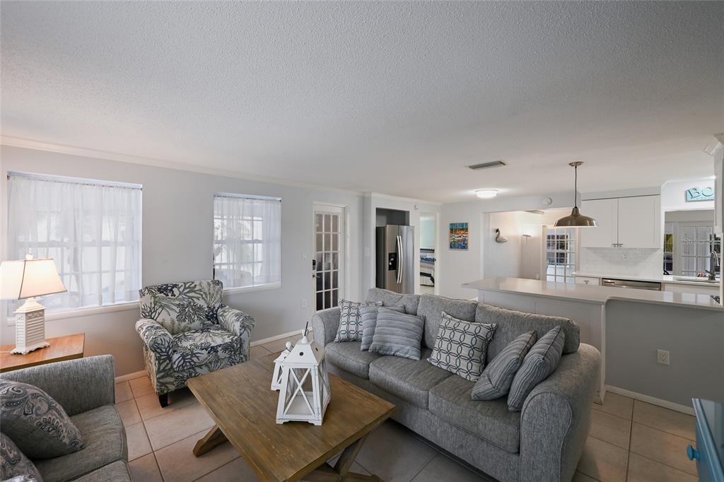 120 Maple Avenue Anna Maria, FL 34216 - Photo 9 of 39 a living room with furniture and a large window