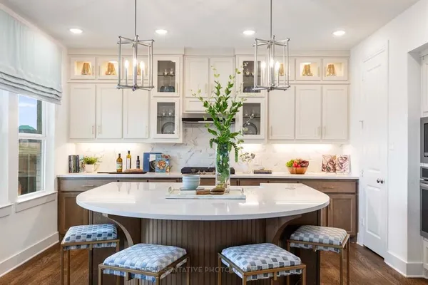 a kitchen with a table chairs sink and cabinets