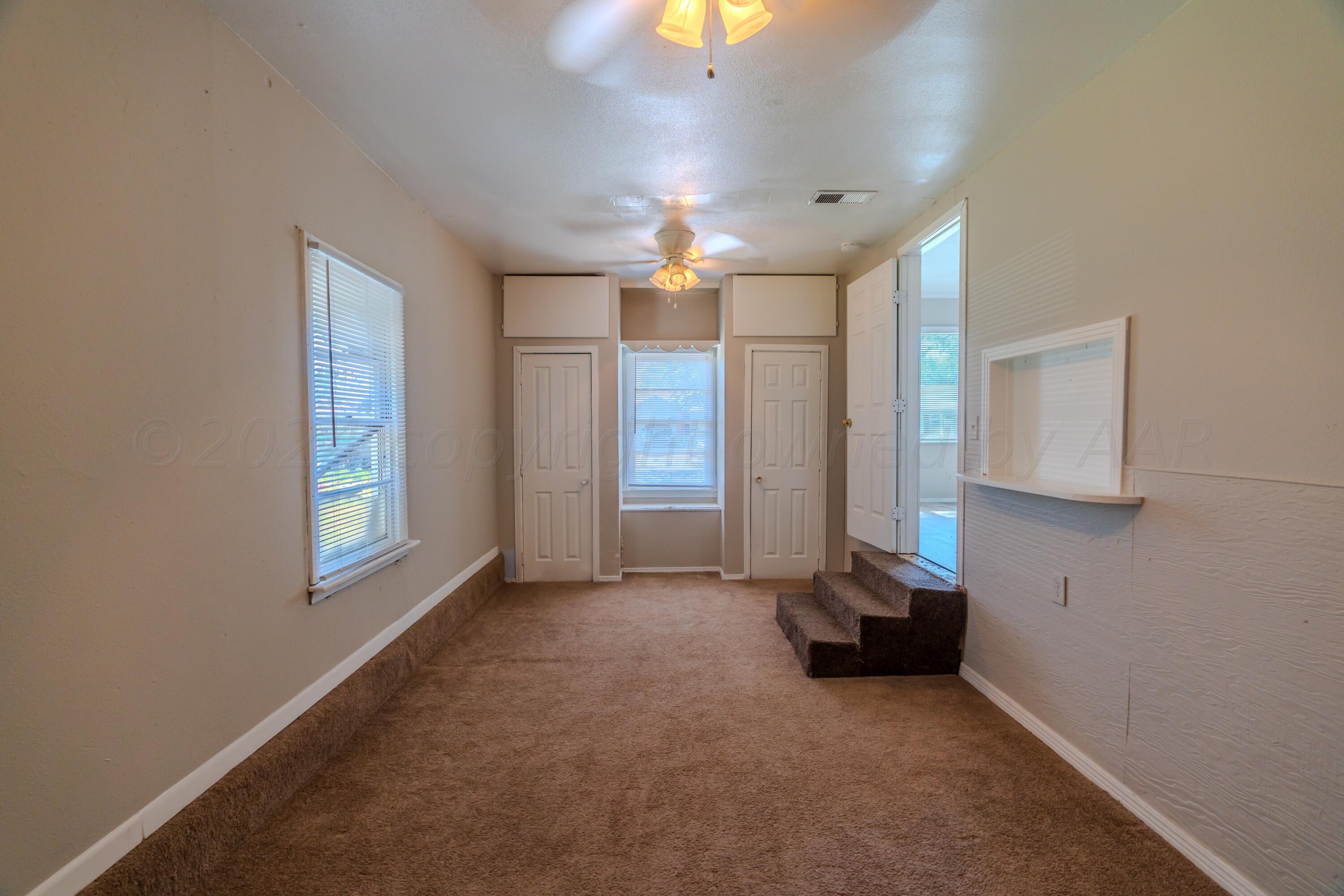 4116 Gables Street Amarillo, TX 79110 - Photo 11 of 13 a view of empty room with window and chandelier fan