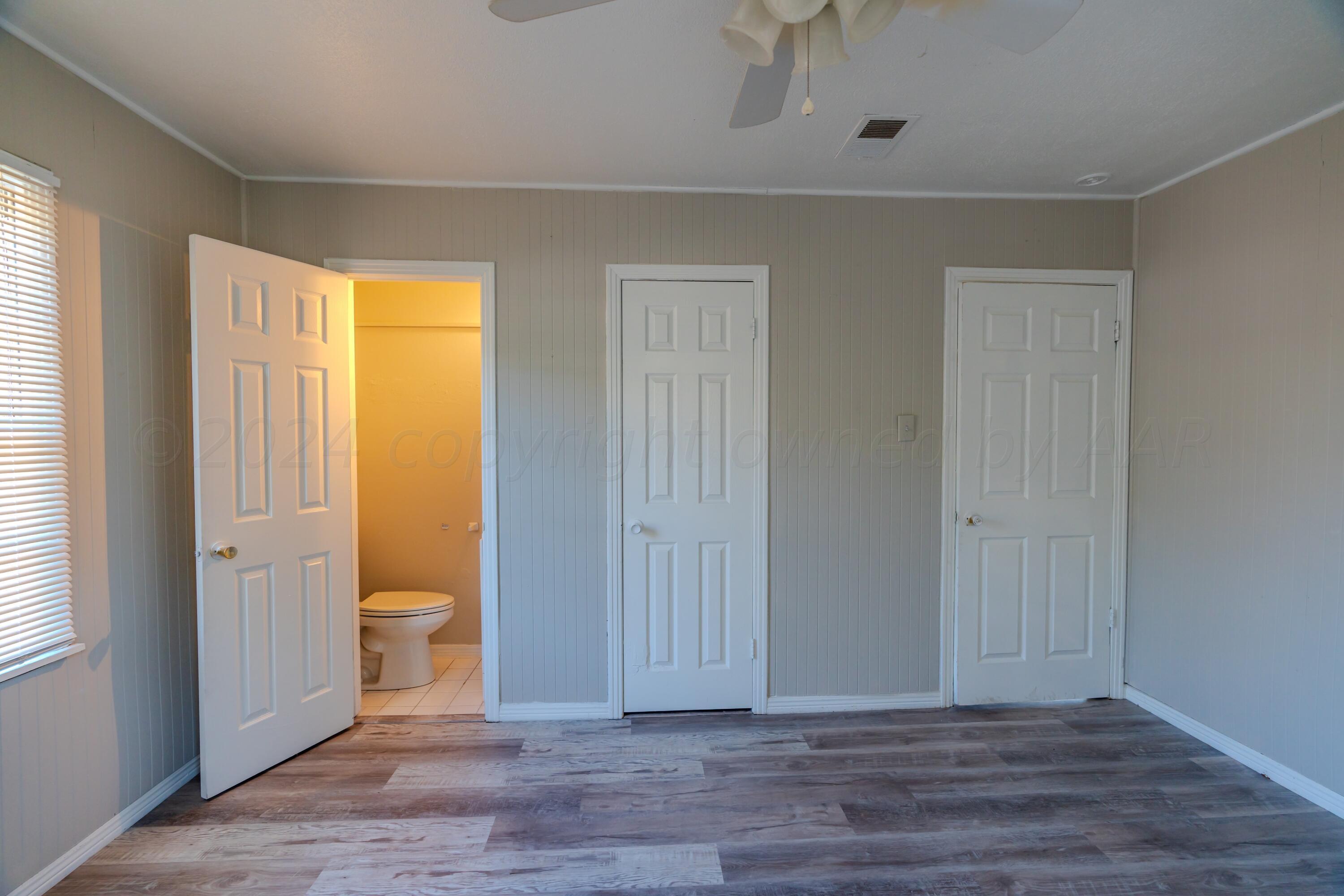 4116 Gables Street Amarillo, TX 79110 - Photo 6 of 13 a view of a room with wooden floor and toilet