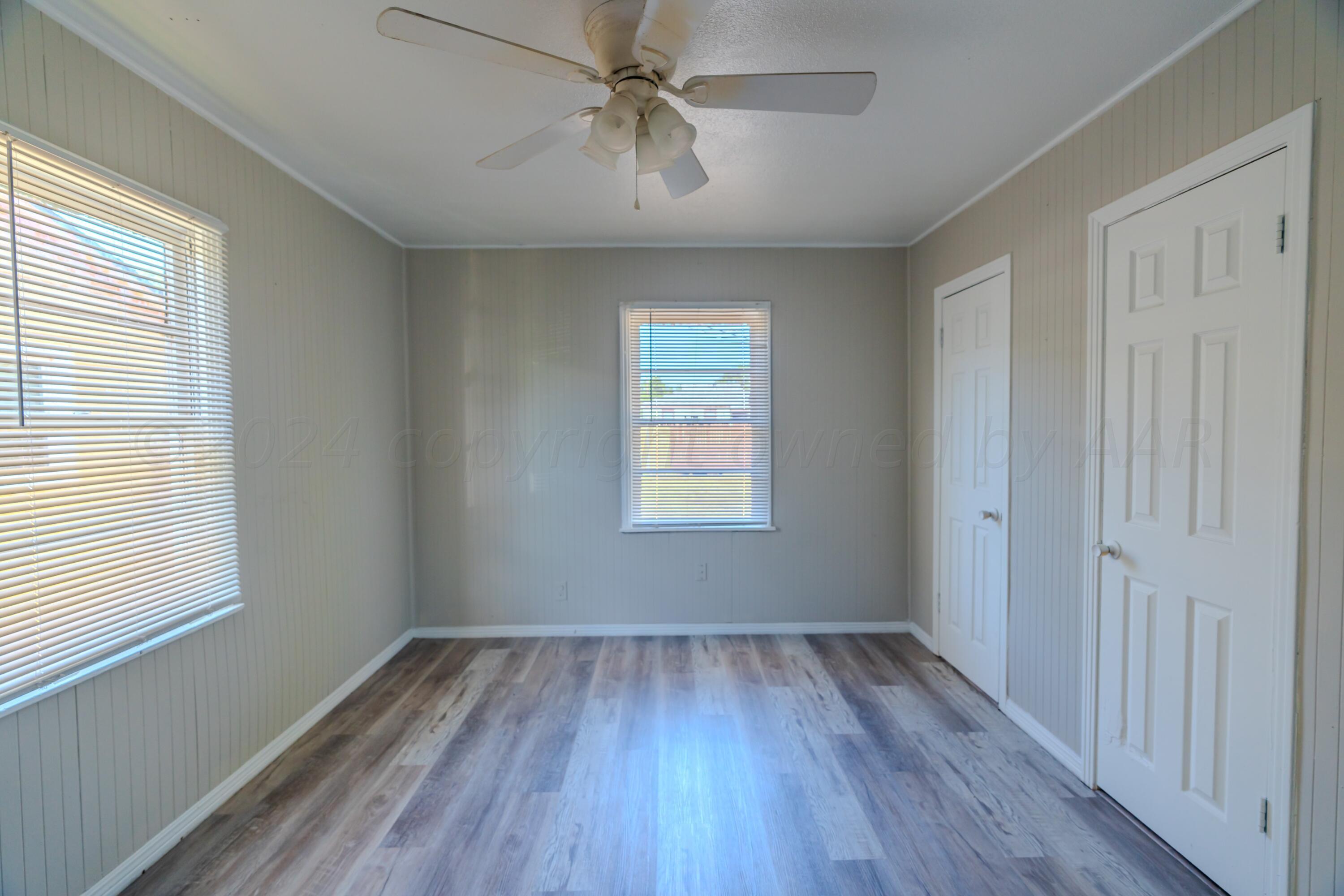 4116 Gables Street Amarillo, TX 79110 - Photo 7 of 13 a view of a room with wooden floor and windows