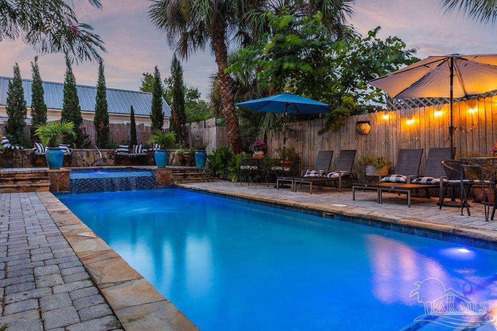 714 East La Rua Street Pensacola, FL 32501 - Photo 40 of 63 a view of swimming pool with chairs and table under an umbrella
