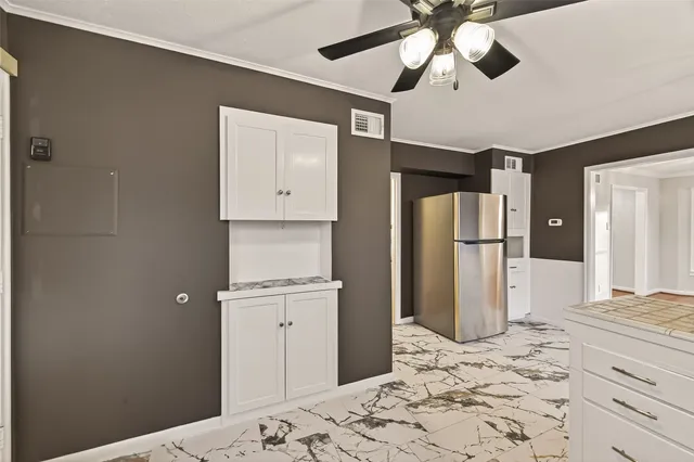 a bathroom with a refrigerator and a chandelier
