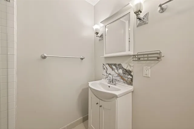 a bathroom with a sink a mirror and shower