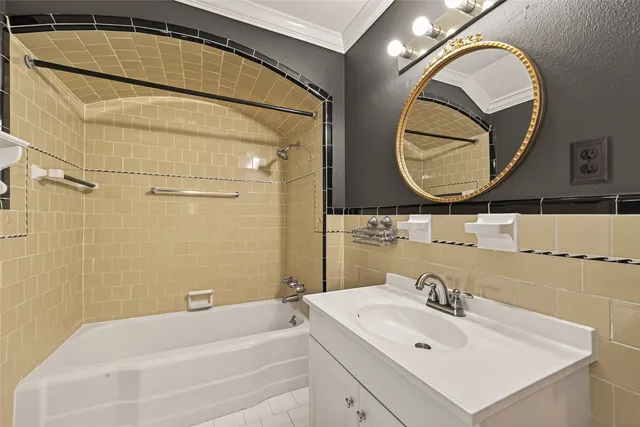 a bathroom with a sink mirror vanity and a bathtub