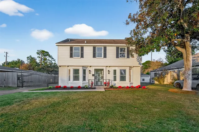 a front view of house with yard and outdoor seating