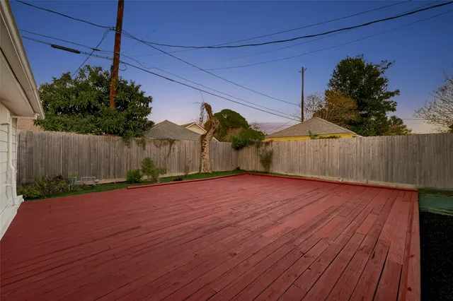 a view of a backyard and wooden fence
