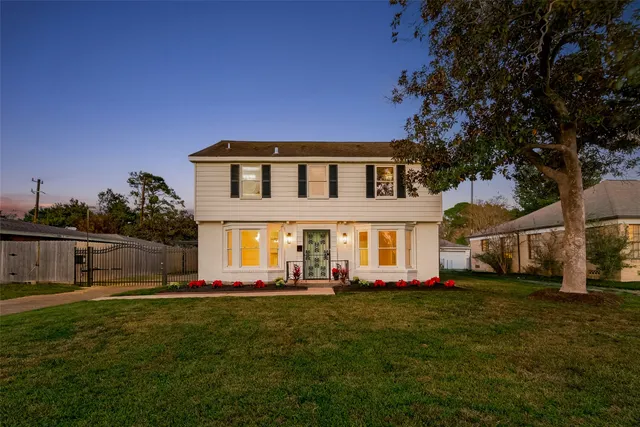 a front view of house with yard and green space
