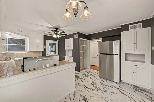 a very nice looking room with a large window and chandelier