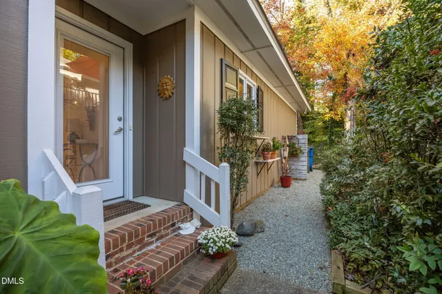 a backyard of a house with table and chairs