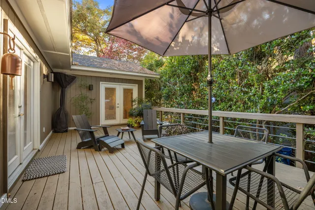 a view of balcony with furniture and umbrella