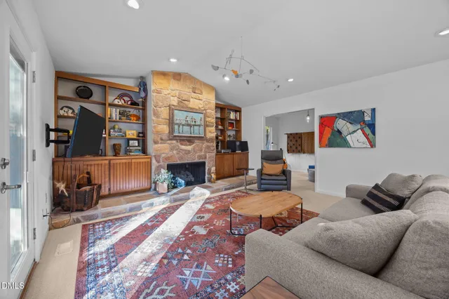 a living room with furniture a fireplace and a flat screen tv