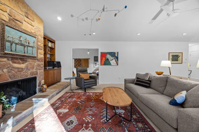 a living room with furniture a fireplace and a flat screen tv
