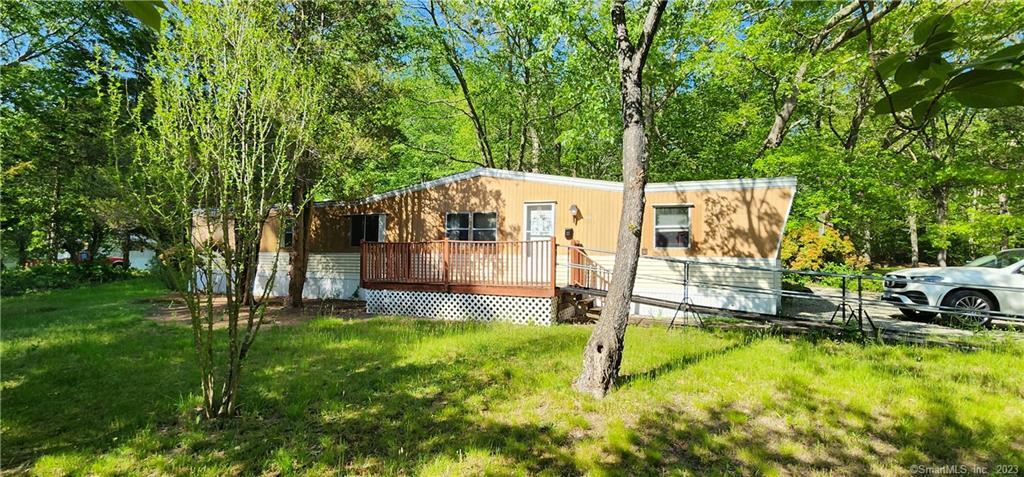 a view of a house with backyard and sitting area