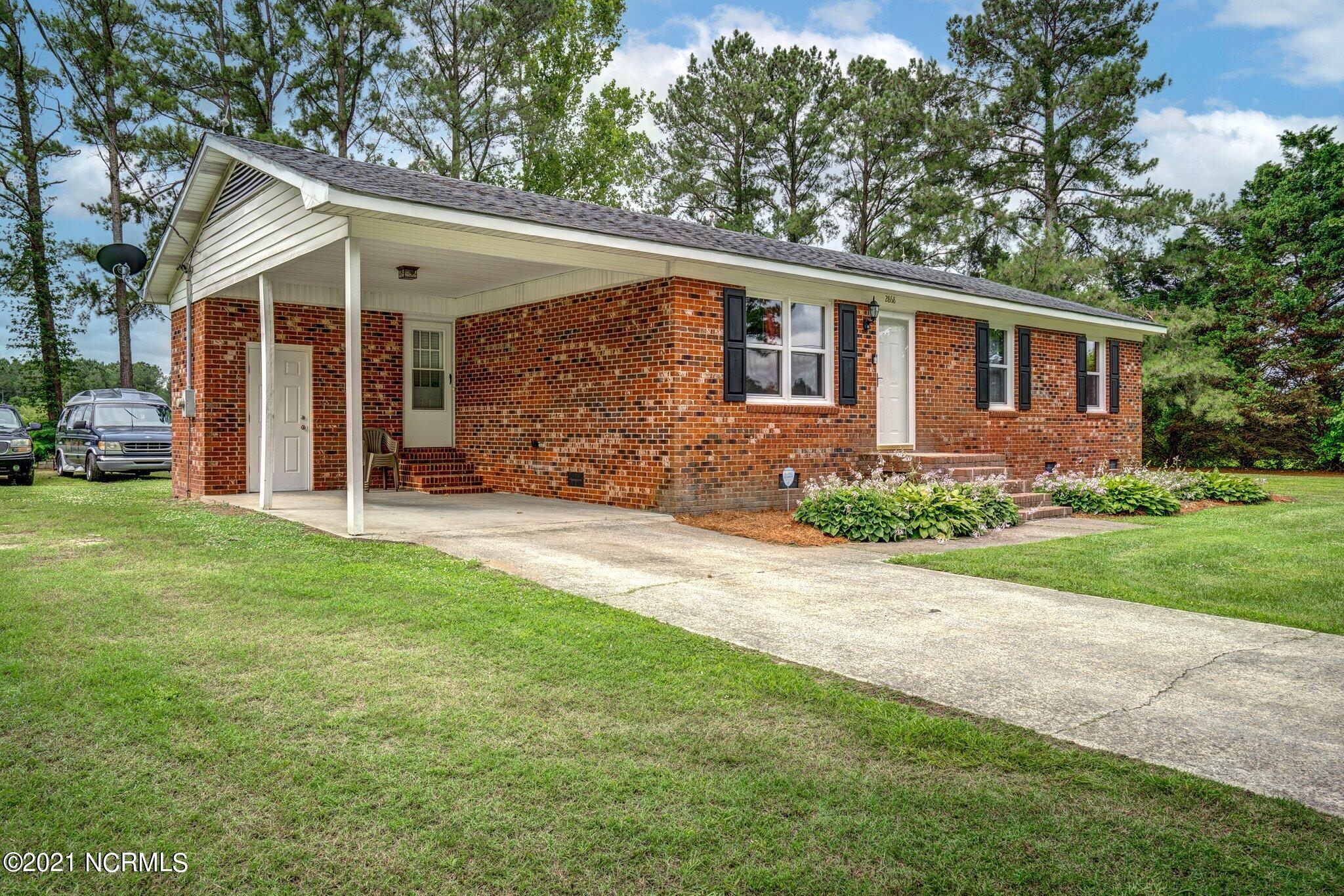 2868 Clemmons School Road Stokes, NC 27884 - Photo 2 of 19 Attached carport has storage shed!