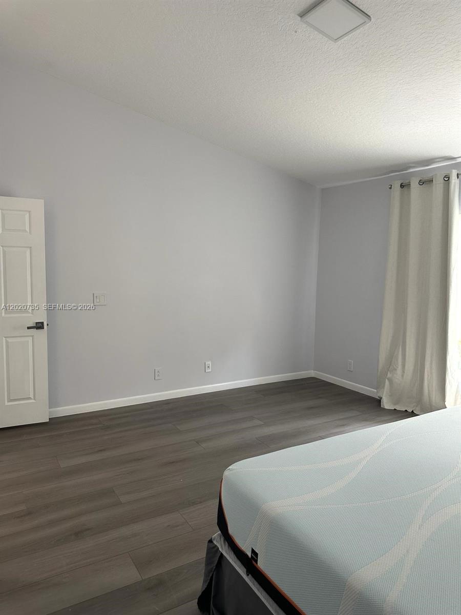 17244 Balboa Point Way Boca Raton, FL 33487 - Photo 13 of 66 a room with a bench and wooden floor