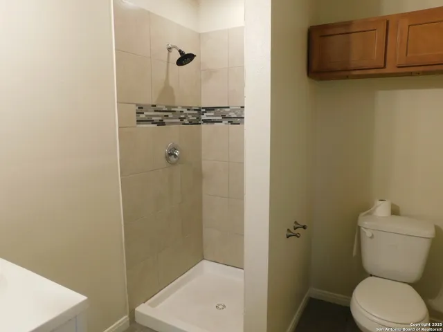 a bathroom with a toilet and a shower