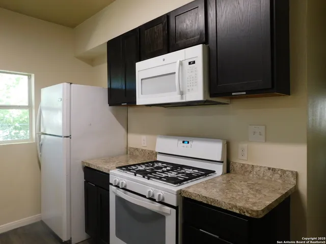 a kitchen with a stove and a microwave