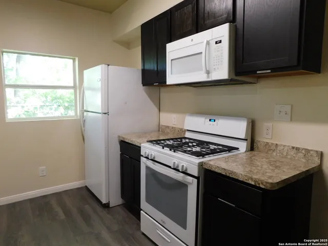 a kitchen with a stove and a microwave