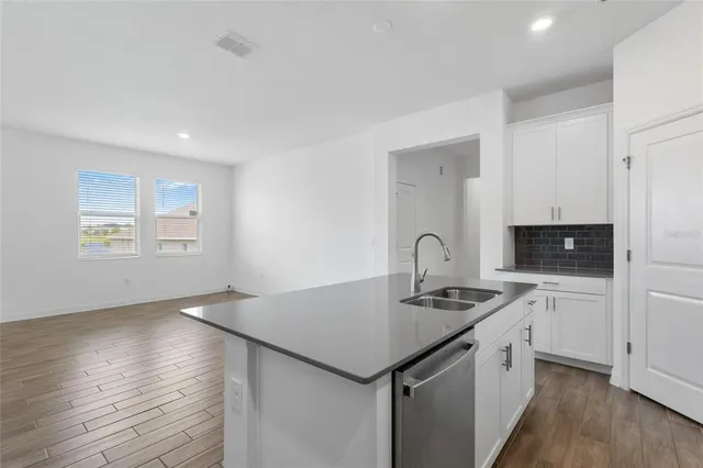 a kitchen that has a sink and a stove in it