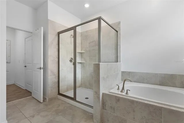 a bathroom with a bathtub and a shower