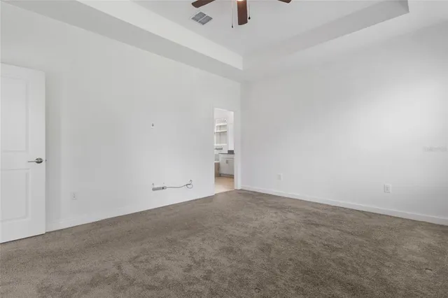 a view of an empty room with a ceiling fan
