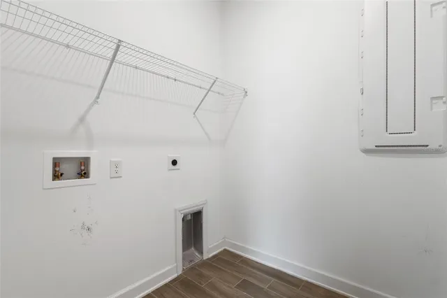 a view of a room with wooden floor