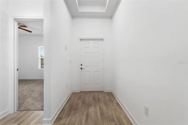 a view of a small space with wooden floor and a bathroom